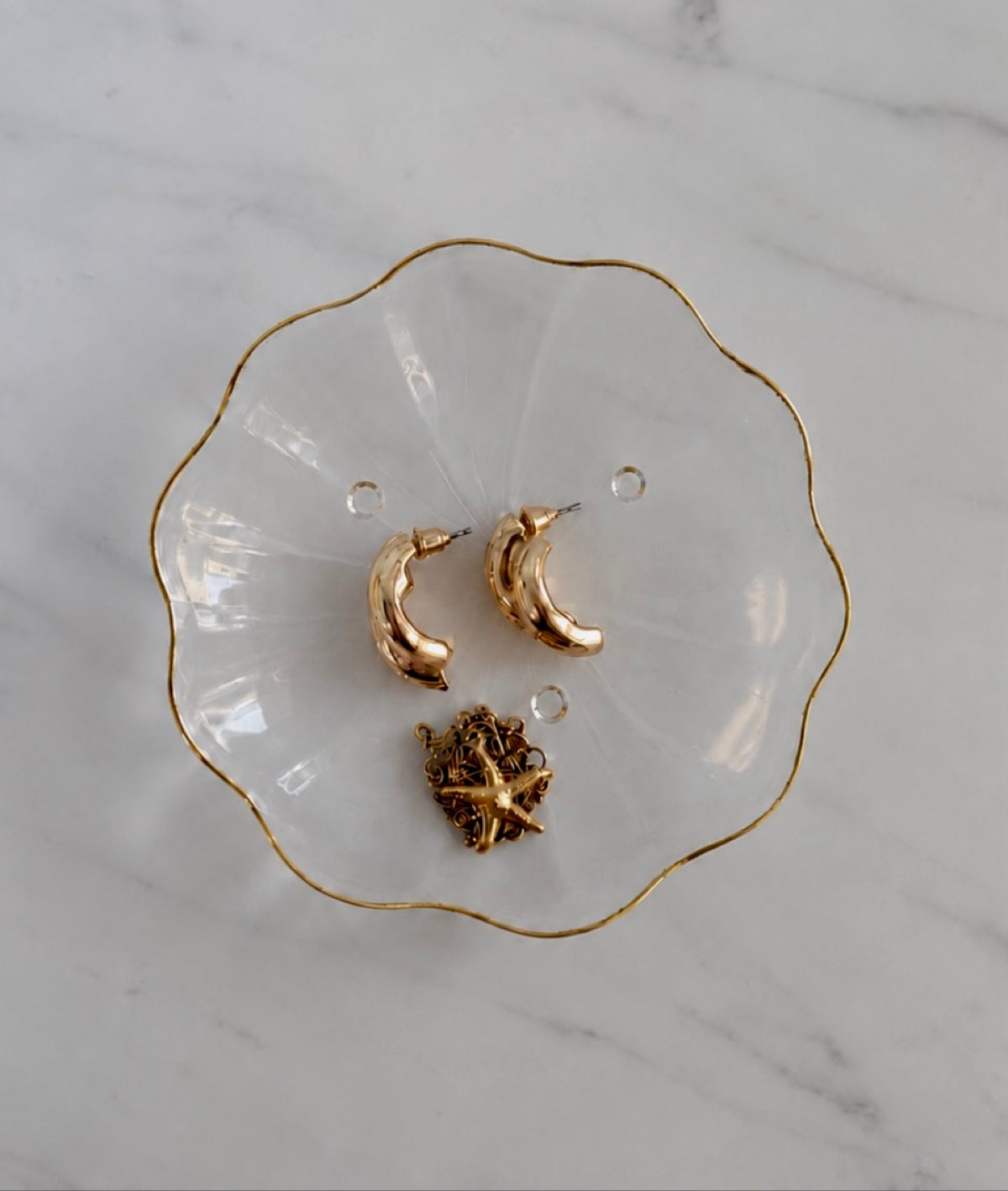 Oullins scalloped glass dish with gold rim styled with gold jewelry