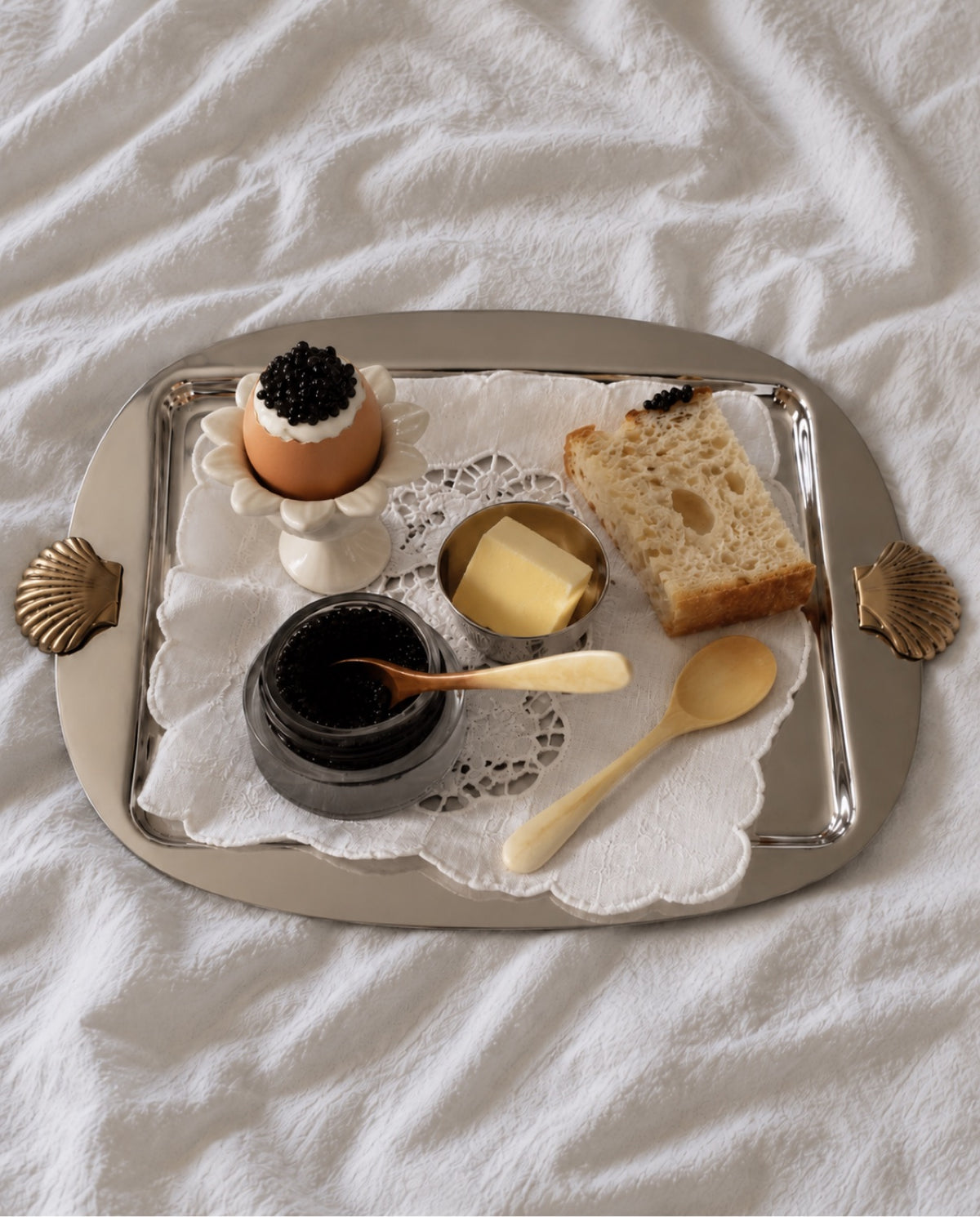 Silver serving tray with caviar breakfast in bed